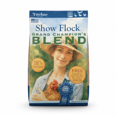 Tucker Show Flock Grand Champion's Blend packaging with a woman holding a rooster and a blue ribbon.